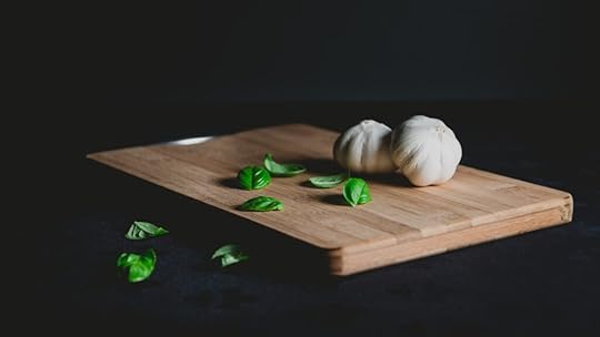 cutting board black background with garlic cloves