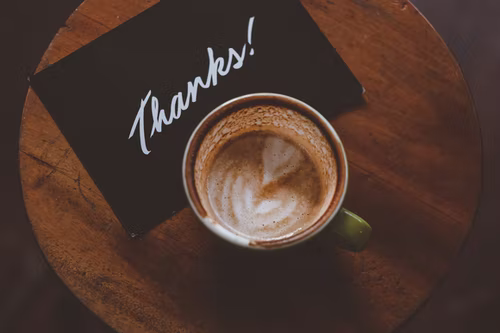 Image of thanks postcard and latte.