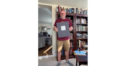 me, holding my NY Times book of front pages
