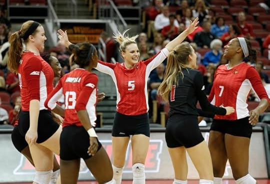 Cardinal Couple Louisville Volleyball cages Clemson
