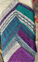 A 15' wide strip knitting in four colors and four patterns