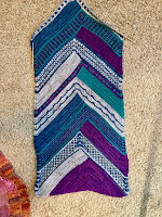 A 15' wide strip knitting in four colors and four patterns