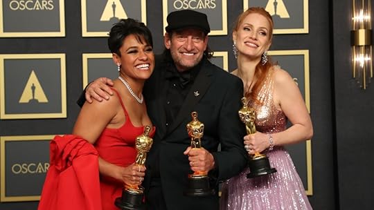 3 Oscar winners standing with their gold statues posing for the cameras.