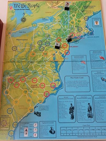 The game board of We the People showing the 13 Colonies of North America, with three standees on it.