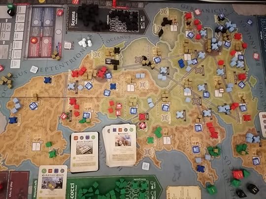 Image of the board, at the top some Saxons have left Roman service and now control a territory. The Scotti are in more places on the board. Still, the board is covered in blue and red Roman pieces.