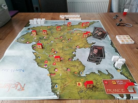 The board, a map of Britain looking south from Scotland. Two hands of cards have been dealt to the Irish Sea. Britain has red blocks positioned across it, white blocks are on Ireland on the right and in Calais on the top left.