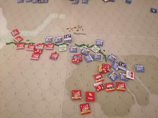 The French units are spread across the middle of the image with the English in the top left and bottom centre. Several chits are on the board indicating where hedges have been trampled by French soldiers.