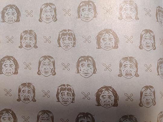 drawings in black on a light brown background of decomposing children's faces