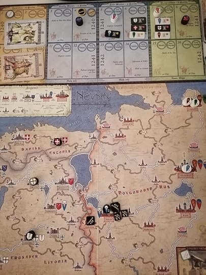 Nevsky's game board. Black Teutonic victory markers are on the cities of Izborsk and Pskov. The Teutonic player has 4 lords on the board to the Rus players 3.