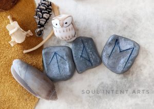 Elder Futhark runes Ehwaz, Thurisaz reversed, then Tiwaz on a whitish background with a dark lettered olive shell