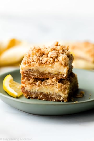 two creamy lemon crumble bars on a green plate