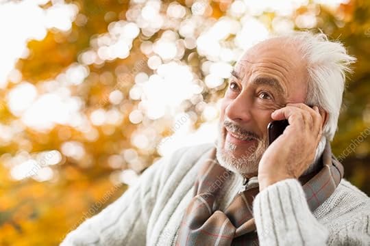 Older man talking on cell phone in park Stock Image