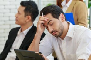 Man looking discouraged in a meeting