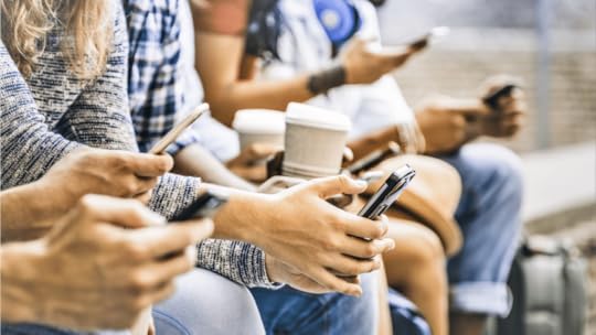 multicultural group on smartphones doing social media background checks
