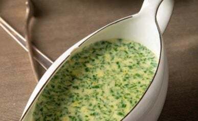 A gravy boat full of British parsley sauce.