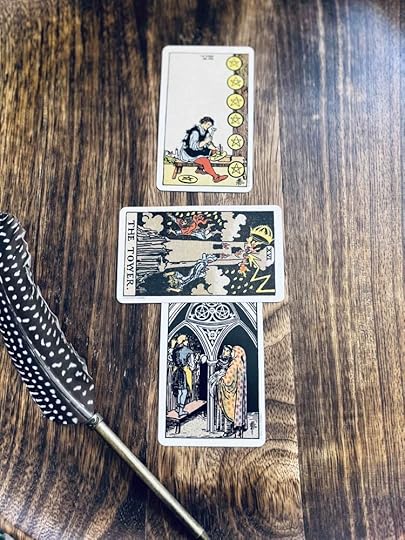 Three tarot cards: the three of pentacles, topped by the tower, with the eight of pentacles above them.