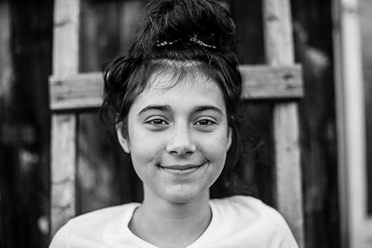 black and white photo of a teenage girl smiling at camera. Dyslexia is like black-and-white photography in a way. Sometimes a limitation imposed on a creative process can produce beautiful results.