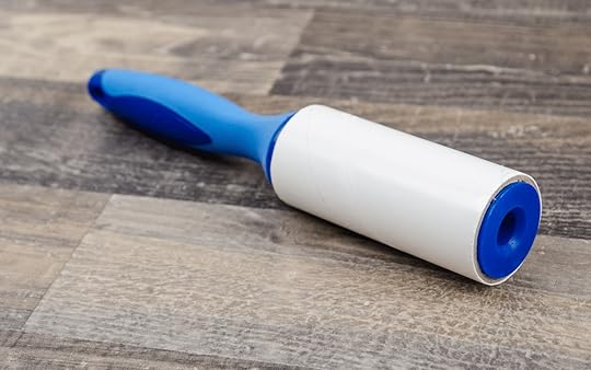 blue lint brush on wooden table