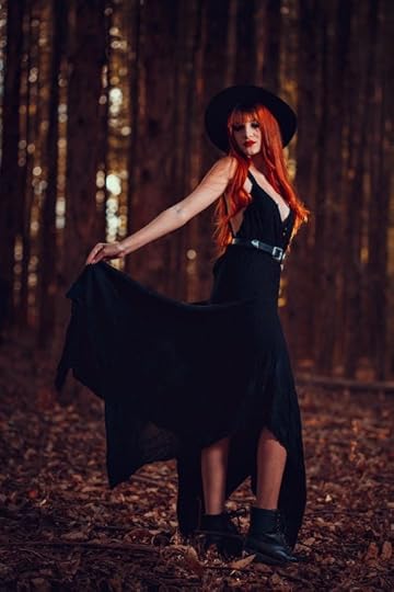 Free Woman in Black Dress Standing on Fallen leaves Stock Photo