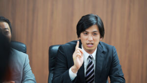 pompous guy in a meeting making a point
