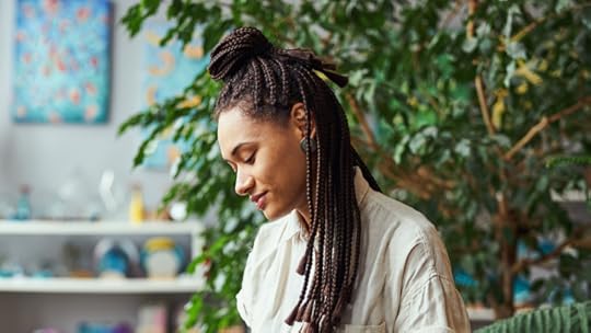 Side view of a concentrated tranquil professional female floral decorator creating a moss wall panel