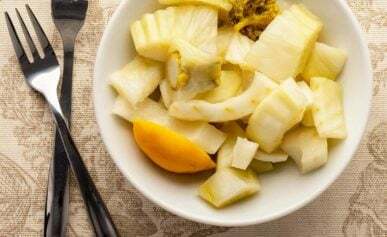 Pickled fennel in a bowl with appetizer forks
