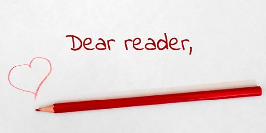 Red pencil on white paper with heart and words Dear Reader