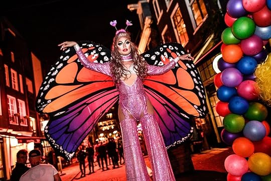 person in butterfly costume in front of gay Amsterdam bar Soho