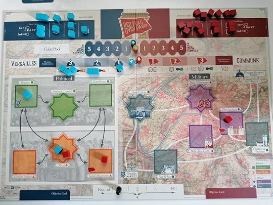 Picture of the Red Flag Over Paris board at set up. Four cubes start in space on the board, the rest are on tracks at the top. The Political side is on the left and the Military, over a map of Paris, on the right