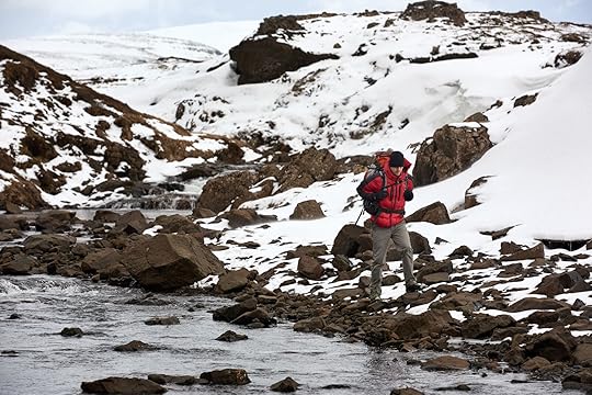 man hiking in puffy jacket ethically sourced down