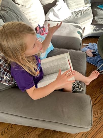 The Littlest Miss discussing a definition in my Merriam-Webster Collegiate Dictionary