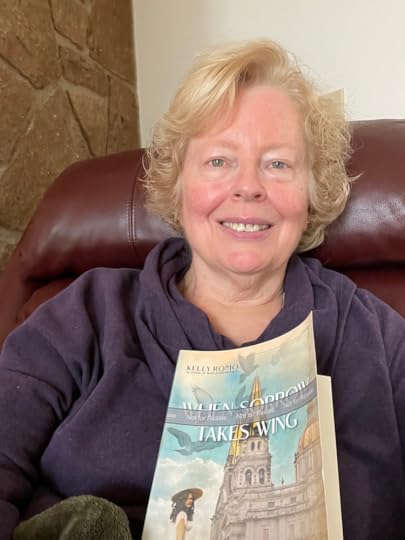 Lady holding a copy of WHEN SORROW TAKES WING