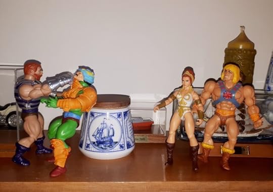 Fisto punches Duncan, while Teela and He-Man look on.