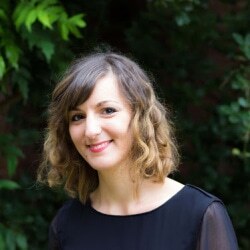 Elisa Cepale standing in front of a tree