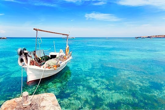 view of crystal blue water with a small boat