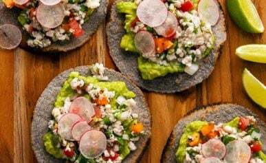 Several ceviche tostadas on a platter with mahi mahi ceviche.