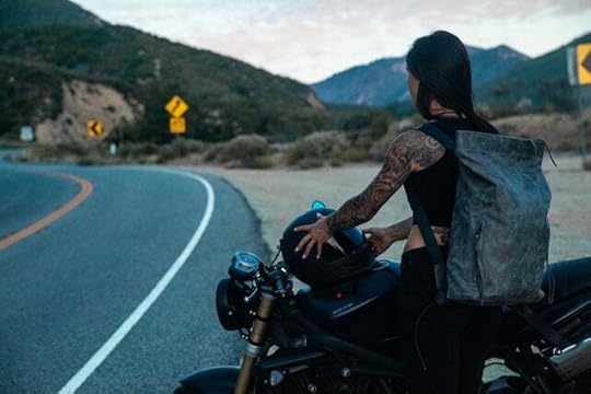 tattooed woman parked on side of highway