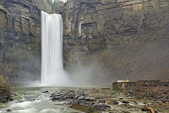 finger lakes new york Taughannock falls with person in yellow raincoat