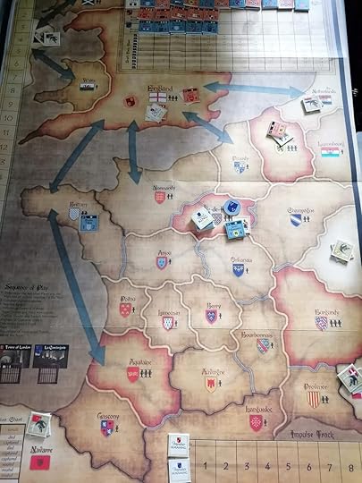 A map of most of France and bordering regions and the British isles divided into regions with game pieces in Paris, Brittany, Flanders, and England.