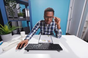 Person working on computer looking dubious
