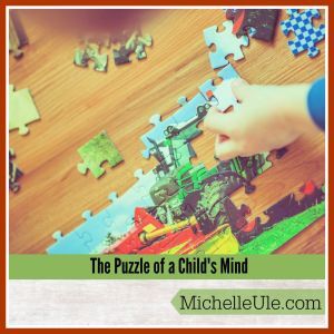 Child putting together a puzzle