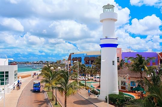 COZUMEL, MEXICO - APRIL 4, 2008: Beautiful quay with white lighthouse attracting thousands of tourists to visit famous shops and restaurants.