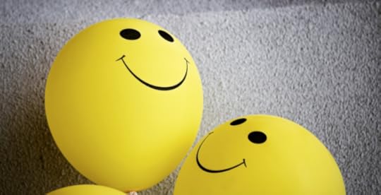Smiley face balloons looking up representing positivity