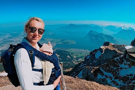 Blond woman on mountain traveling with baby