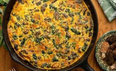 A mushroom spinach frittata in a cast iron pan.