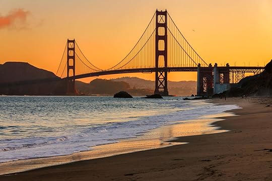 nighttime beach view with bridge in the background