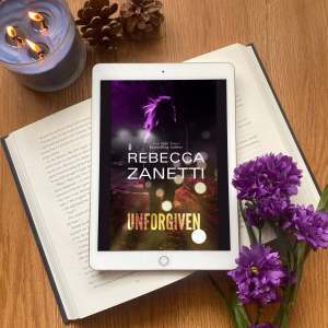 Picture of the book surrounded by purple flowers and a blue candle