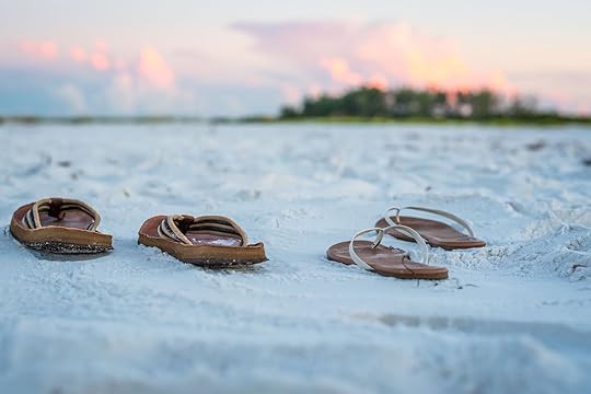 Sandals on the Beach Sand at Sunrise