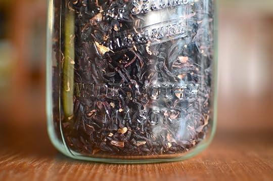 Close up of a jar of dried hibiscus blossoms.