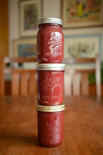 Tower of three full jars of strawberry hibiscus butter.